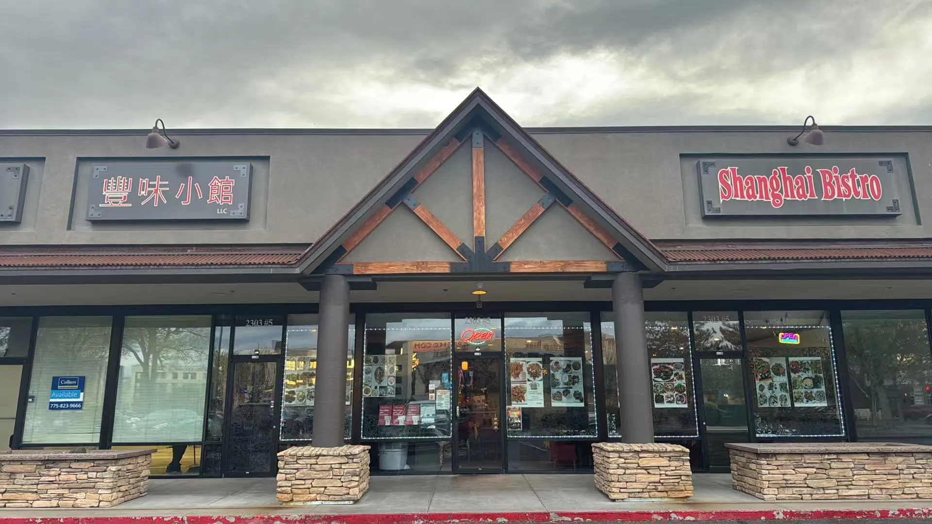 Storefront of Shanghai Bistro restaurant with a wooden gabled roof and large glass windows.